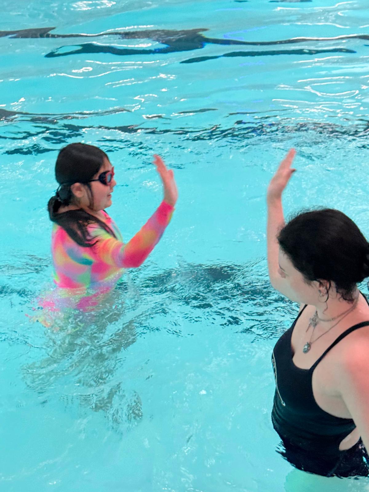A Glass Court instructor assessing a swimmer