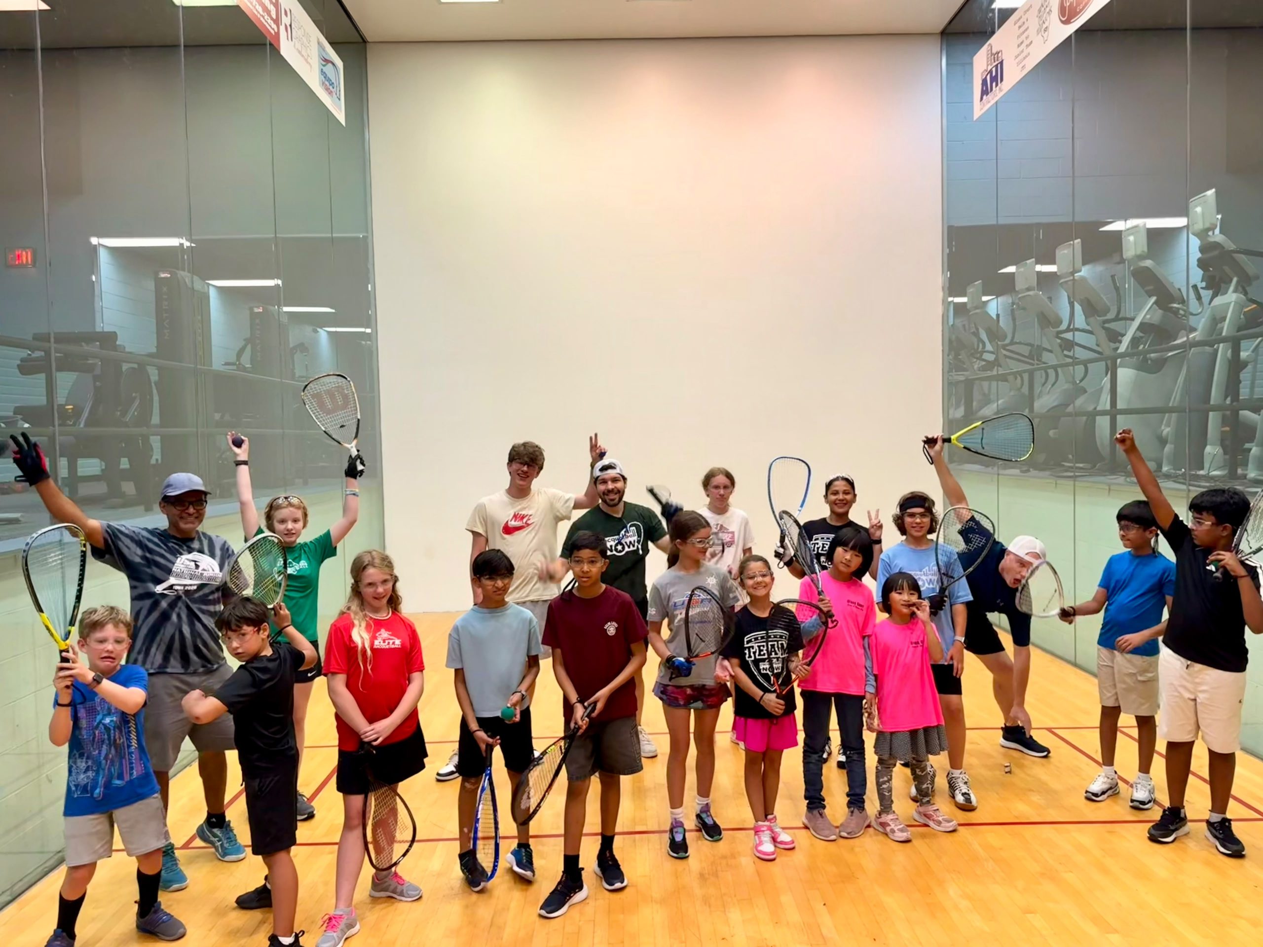 Young players on the racquetball court during a Glass Court youth racquetball program