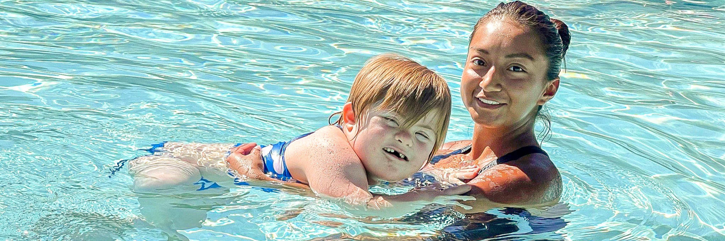 A Glass Court instructor with a child during a one-on-one swim lesson